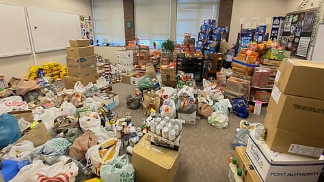 Multiple donated food items filling a classroom.