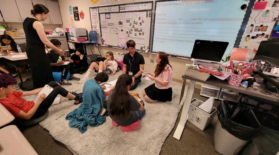 Students of the teaching careers class in a elementary classroom teaching young students